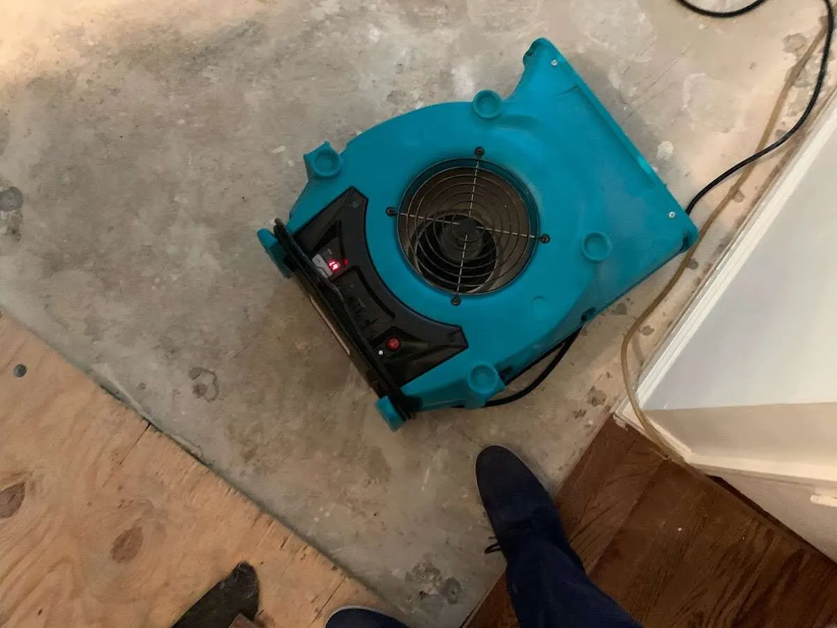 Air mover drying subfloor during Commercial Water Damage Restoration in Laplace